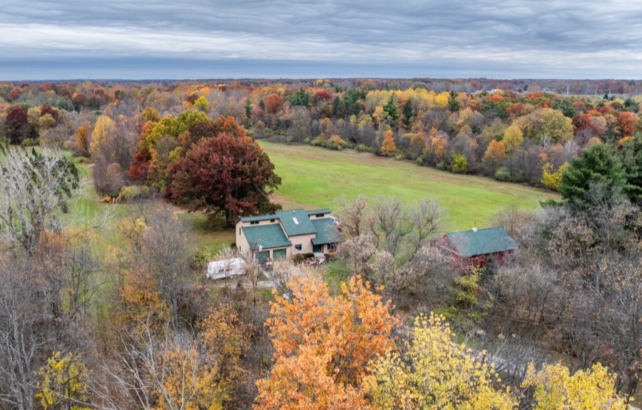 Aerial of 4700 Stanley Rd, Columbiaville MI: house, barn, tree rows and fields