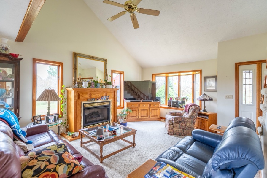 Open-concept living room with vaulted ceiling and fireplace